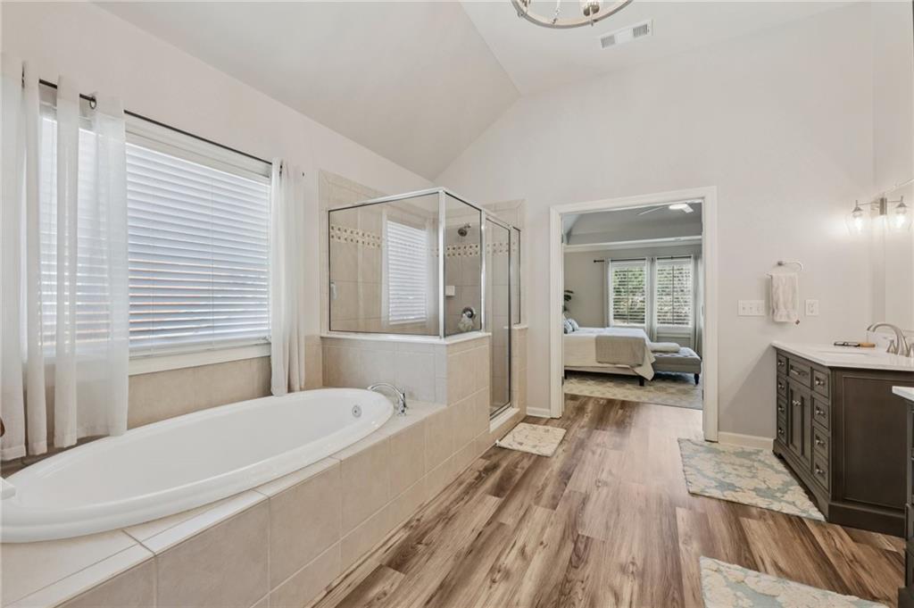 5775 Cascade Trail Cumming, GA 30040 - Photo 21 of 49 a en suite spacious bathroom with a granite countertop tub and a sink