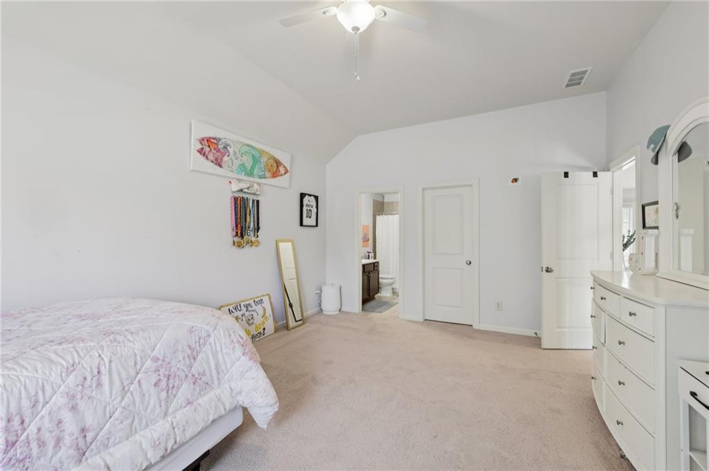 5775 Cascade Trail Cumming, GA 30040 - Photo 23 of 49 a bedroom with a bed and a chandelier