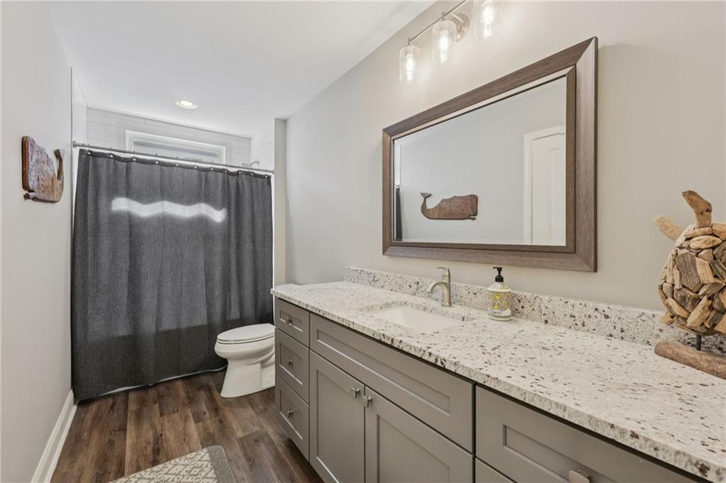 5775 Cascade Trail Cumming, GA 30040 - Photo 30 of 49 a bathroom with a granite countertop sink mirror vanity and toilet