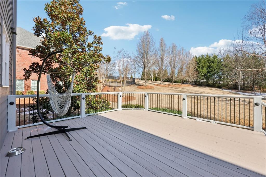 5775 Cascade Trail Cumming, GA 30040 - Photo 32 of 49 a view of a roof deck with wooden floor and fence