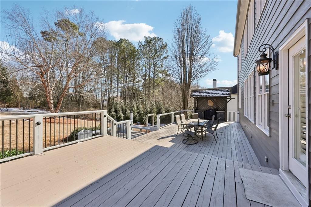 5775 Cascade Trail Cumming, GA 30040 - Photo 33 of 49 a view of balcony with couch and wooden floor