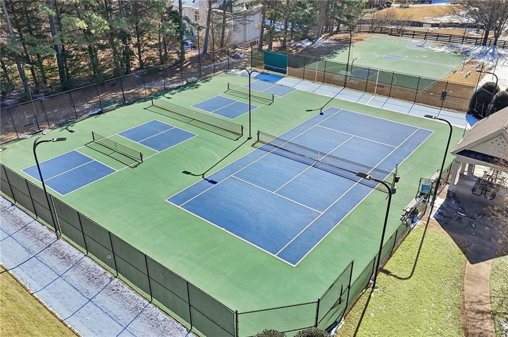 5775 Cascade Trail Cumming, GA 30040 - Photo 46 of 49 a view of a tennis ground with large trees