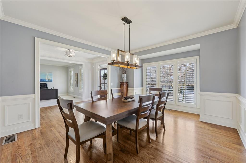 5775 Cascade Trail Cumming, GA 30040 - Photo 5 of 49 a dining room with furniture window and wooden floor