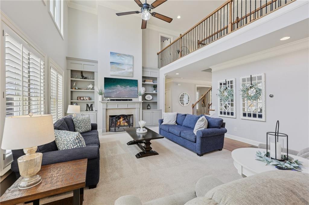 5775 Cascade Trail Cumming, GA 30040 - Photo 8 of 49 a living room with furniture fireplace and a flat screen tv