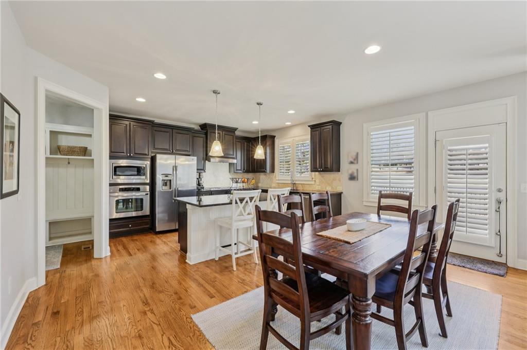 5775 Cascade Trail Cumming, GA 30040 - Photo 10 of 49 a view of a dining room with furniture and wooden floor