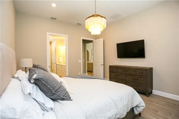 a bedroom with a bed and a flat screen tv