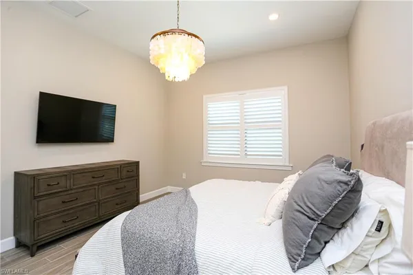 a bedroom with a bed and flat screen tv