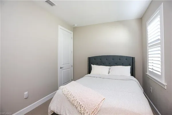 a bedroom with a bed and window