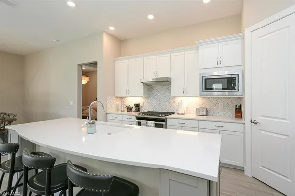 a kitchen with a sink a stove a table and chairs
