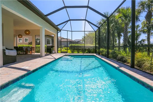 a view of a patio with a table and chairs under an umbrella