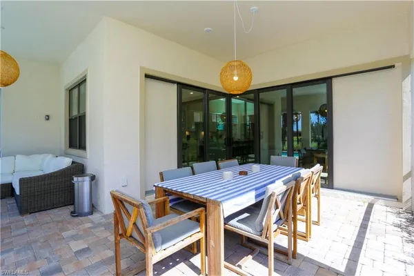 a view of a dining room with furniture wooden floor and chandelier