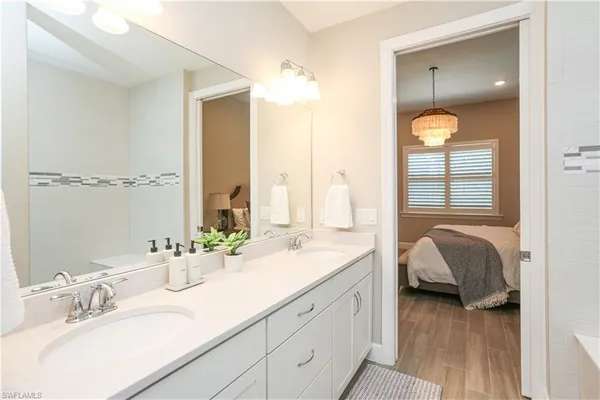 a en suite bathroom with a double vanity sink and a mirror
