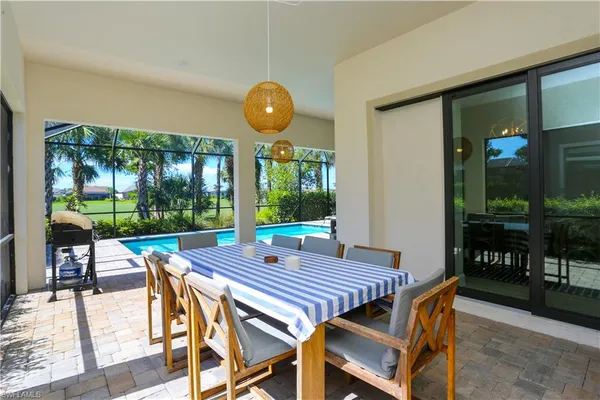 a view of a dinning table and chairs in patio of the house