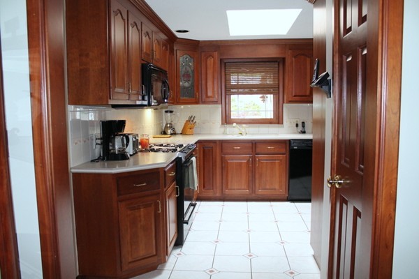 89 Calley Street Springfield, MA 01129 - Photo 4 of 30 a kitchen with stainless steel appliances granite countertop a stove top oven sink and cabinets