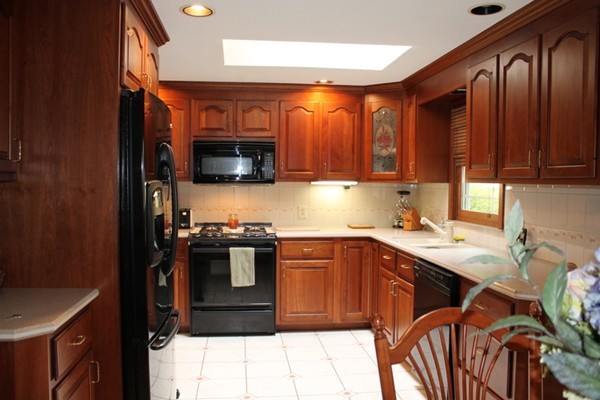 89 Calley Street Springfield, MA 01129 - Photo 6 of 30 a kitchen with stainless steel appliances granite countertop a stove a sink and a microwave