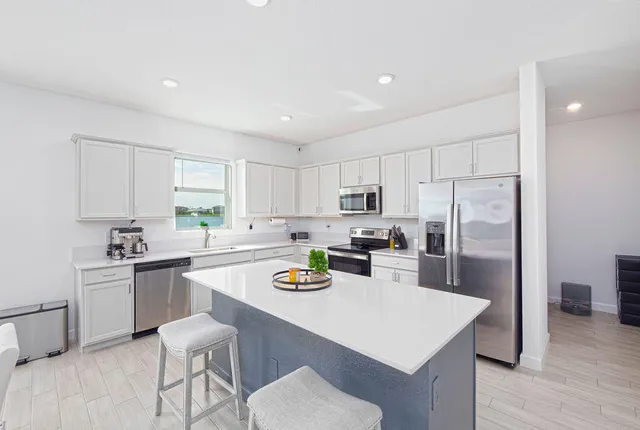 a kitchen with stainless steel appliances stove refrigerator and cabinets