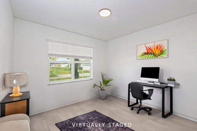 a living room with furniture cabinets and a window