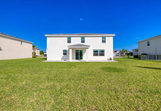 a view of a dining room with furniture a chandelier and wooden floor