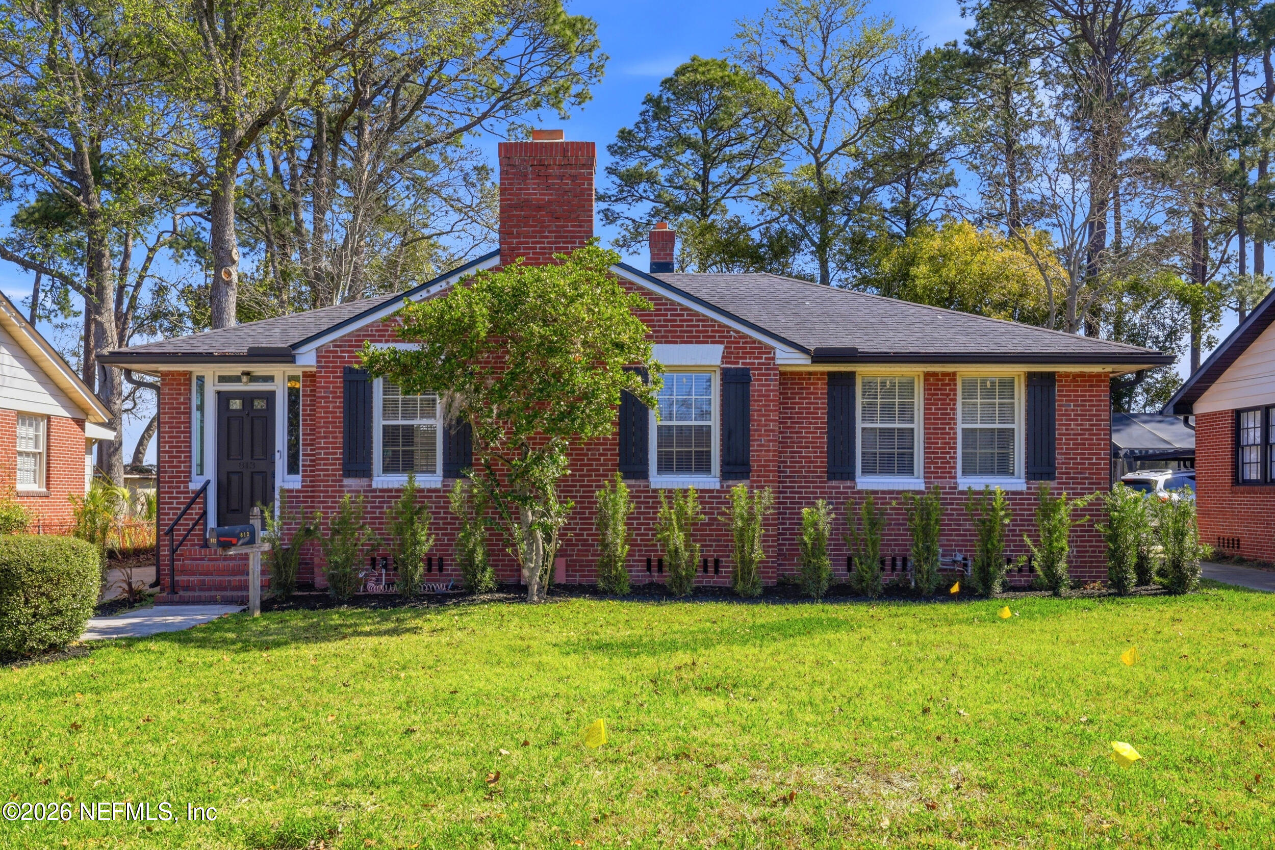 a view of a house with a yard and plants