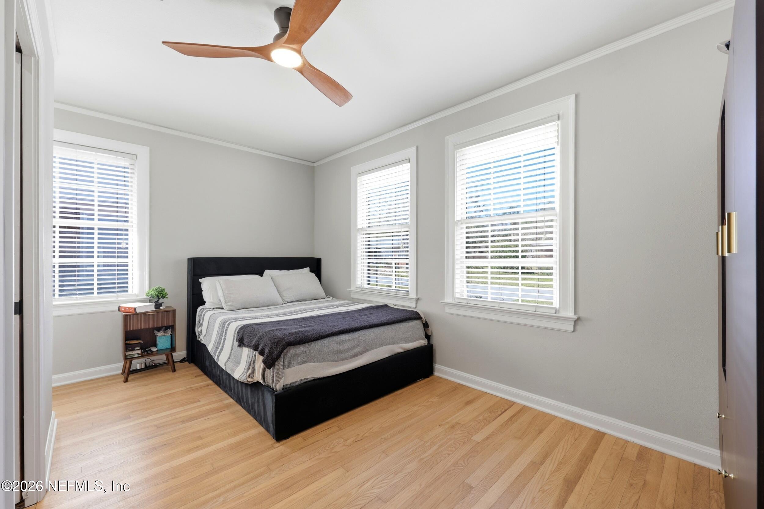 813 Old Hickory Road Jacksonville, FL 32207 - Photo 16 of 28 a spacious bedroom with a bed lamp closet and a large window
