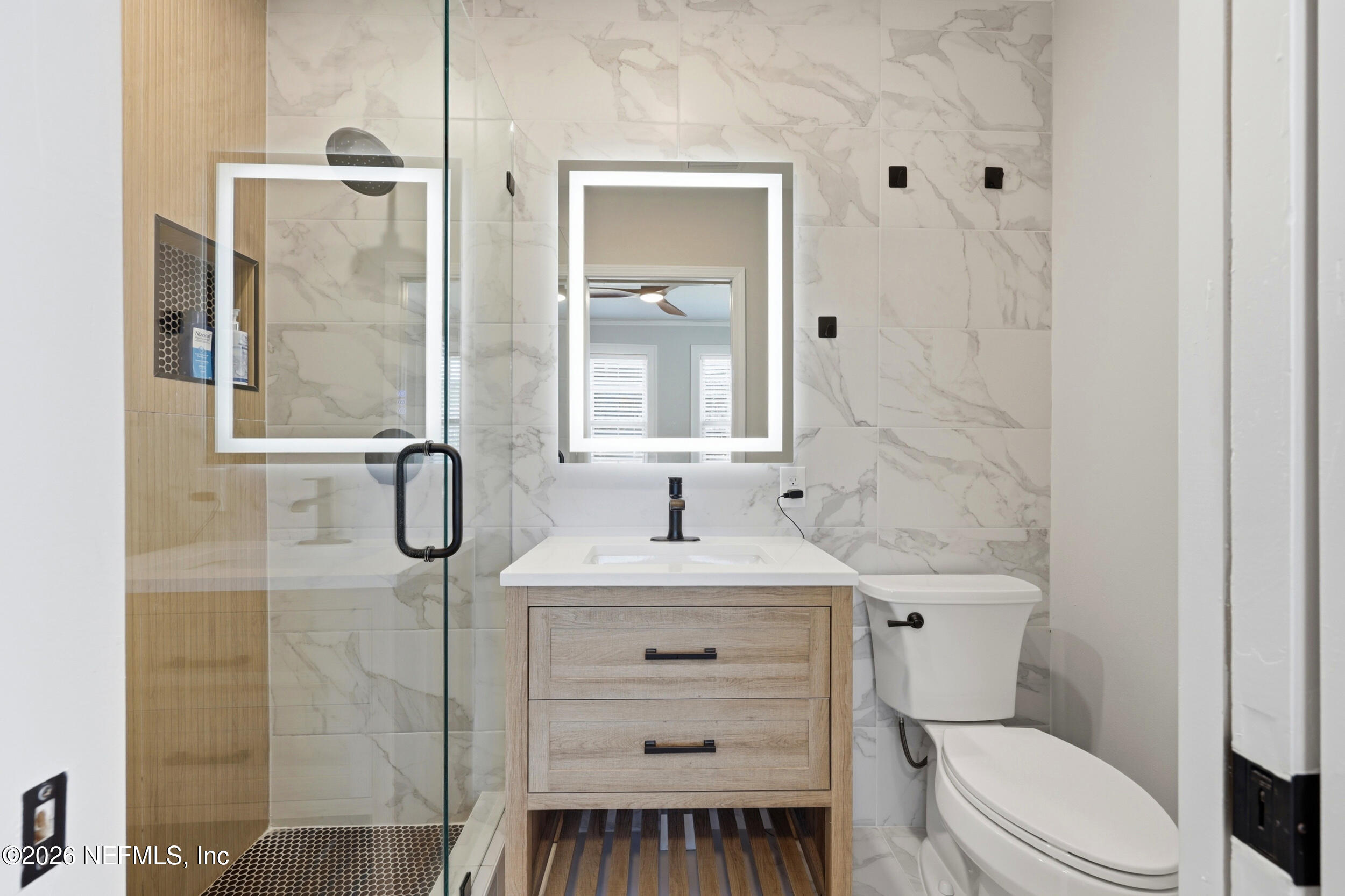 813 Old Hickory Road Jacksonville, FL 32207 - Photo 18 of 28 a bathroom with a sink toilet vanity and shower