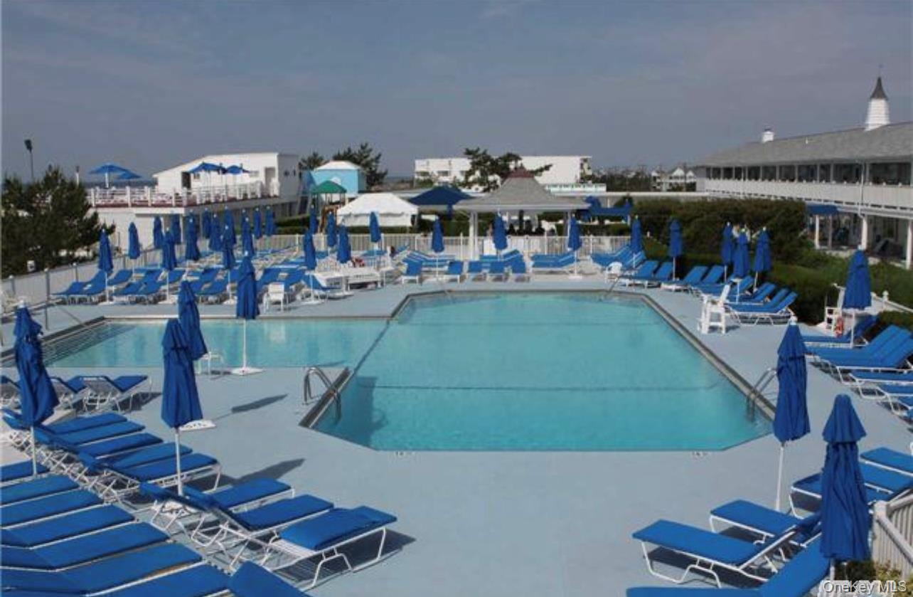 231 Dune Road, Unit 905 Westhampton Beach, NY 11978 - Photo 15 of 24 Community pool featuring a patio area