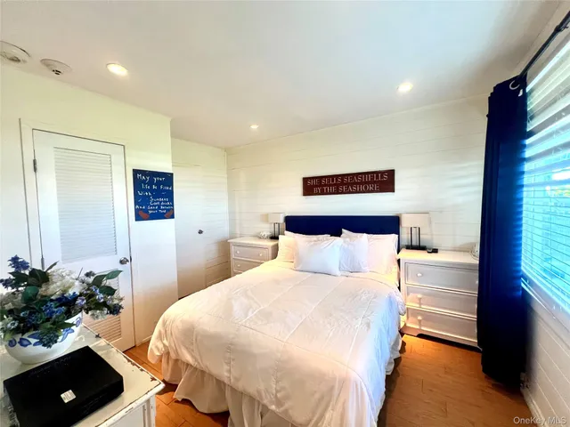 a bedroom with a bed and a potted plant