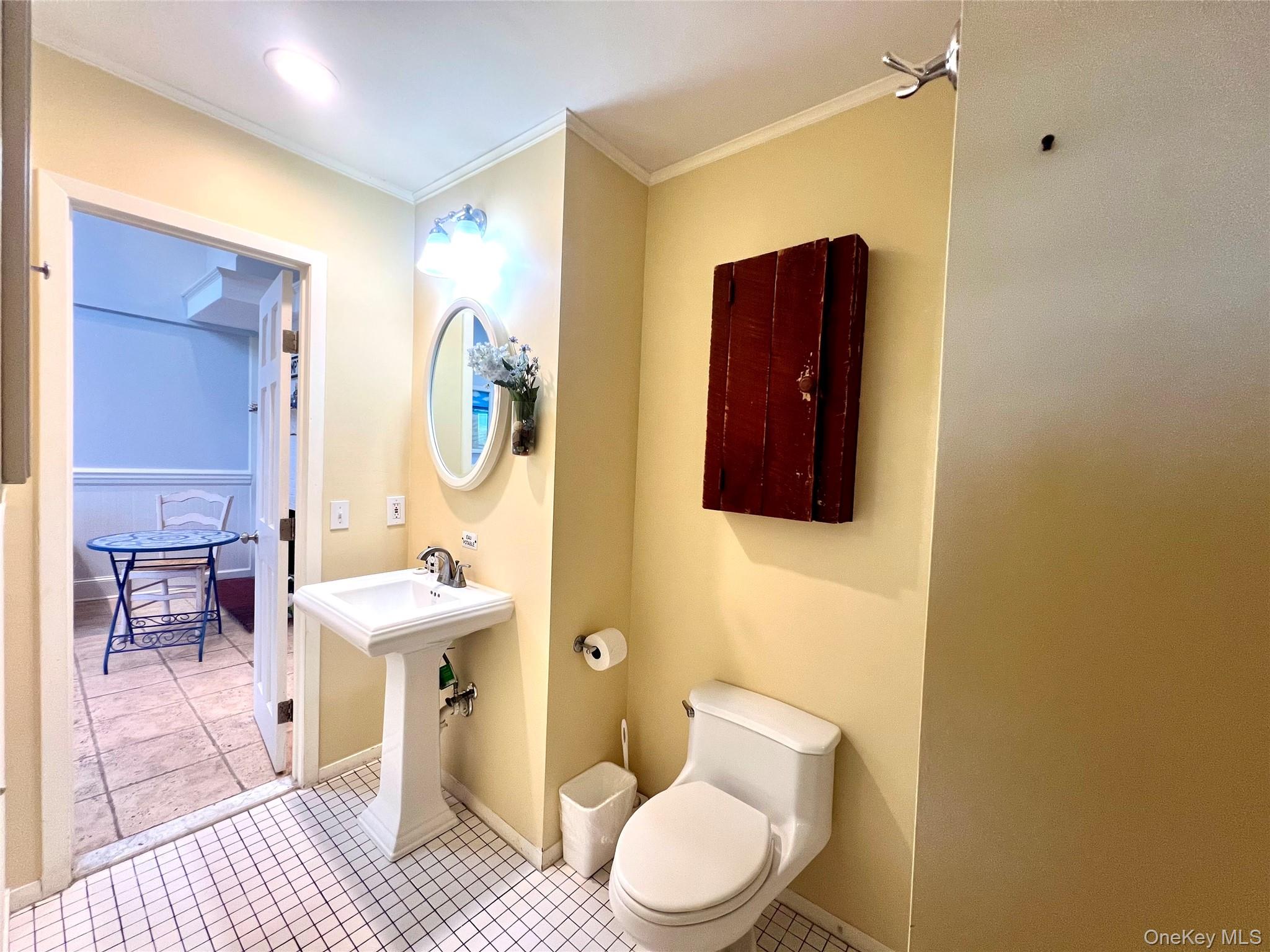 231 Dune Road, Unit 905 Westhampton Beach, NY 11978 - Photo 6 of 24 Full bath with tile patterned floors and ornamental molding