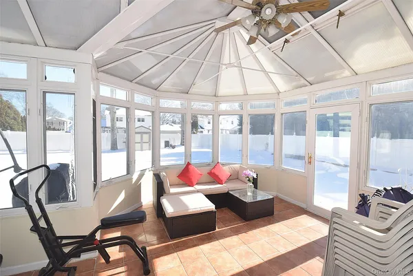 a living room with furniture and floor to ceiling windows