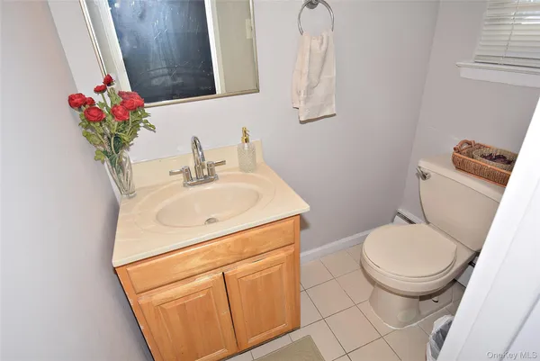 a bathroom with a sink toilet and a mirror
