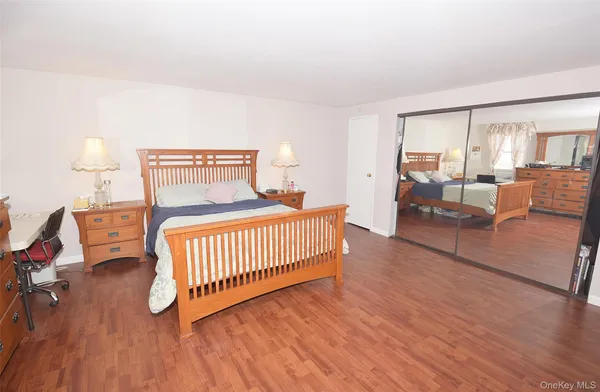 a bedroom with furniture and a wooden floor