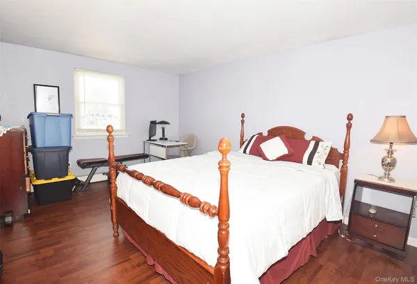 a bed room with a bed and a chair