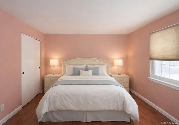 a bedroom with a bed and windows