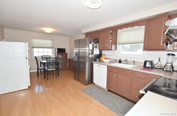 a kitchen with granite countertop cabinets and refrigerator
