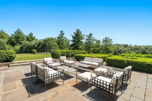 a view of backyard with seating area and green space
