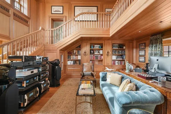 a living room with furniture fireplace and a large window