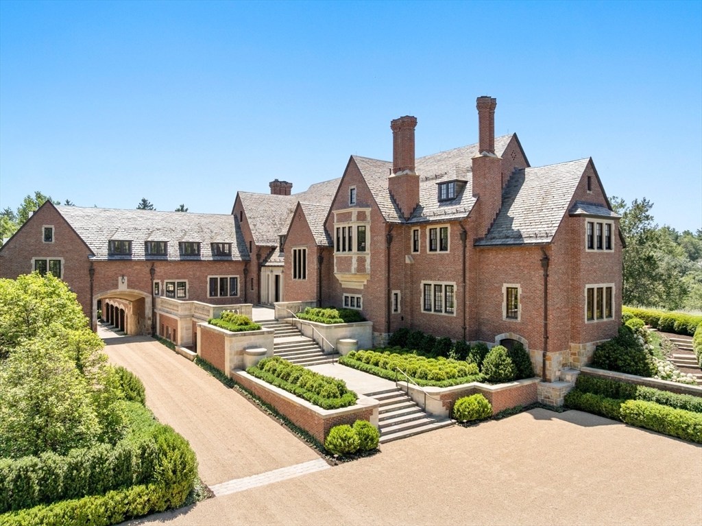 4 Willow Road Weston, MA 02493 - Photo 3 of 42 a front view of a house with a garden and plants