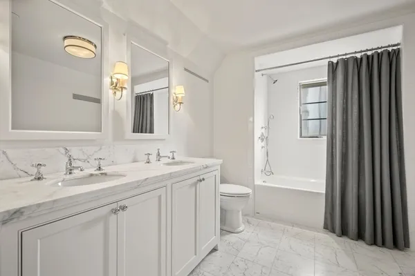 a view of a white house with a big yard and large trees