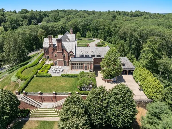 an aerial view of a house with a yard