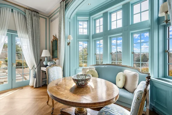 a living room with furniture and a floor to ceiling window