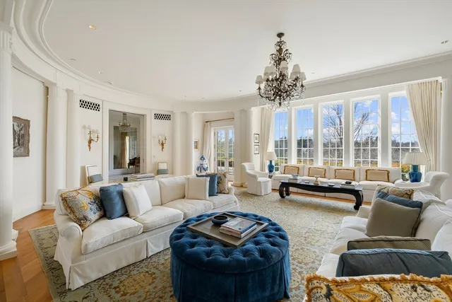 a living room with furniture and floor to ceiling windows