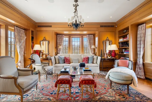 a very nice looking living room with furniture and a chandelier