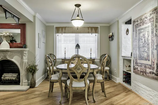 a livingroom with fireplace dining room and wooden floor