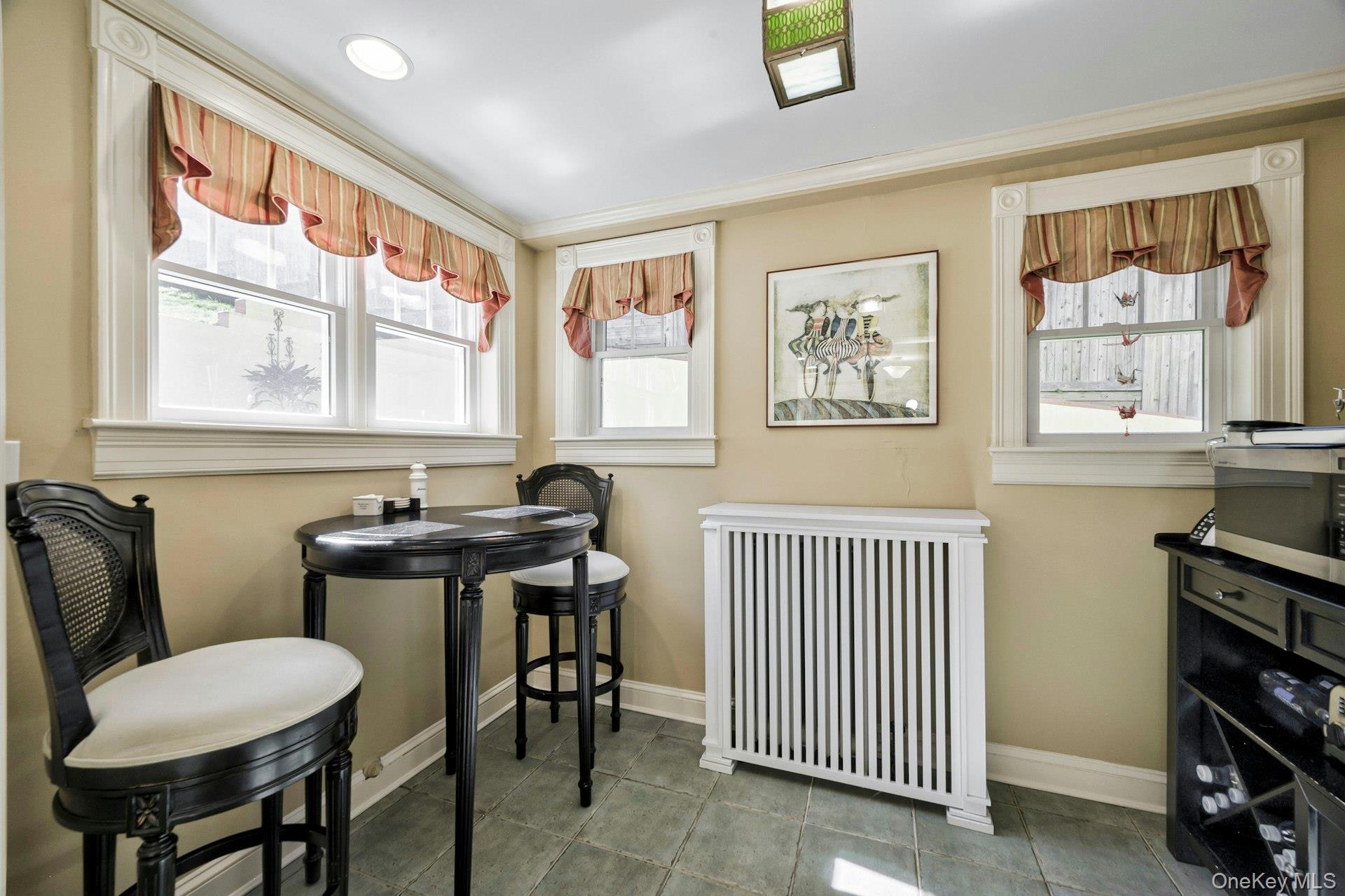 126 Cove Road Oyster Bay, NY 11771 - Photo 17 of 42 Sitting room with radiator and tile patterned floors