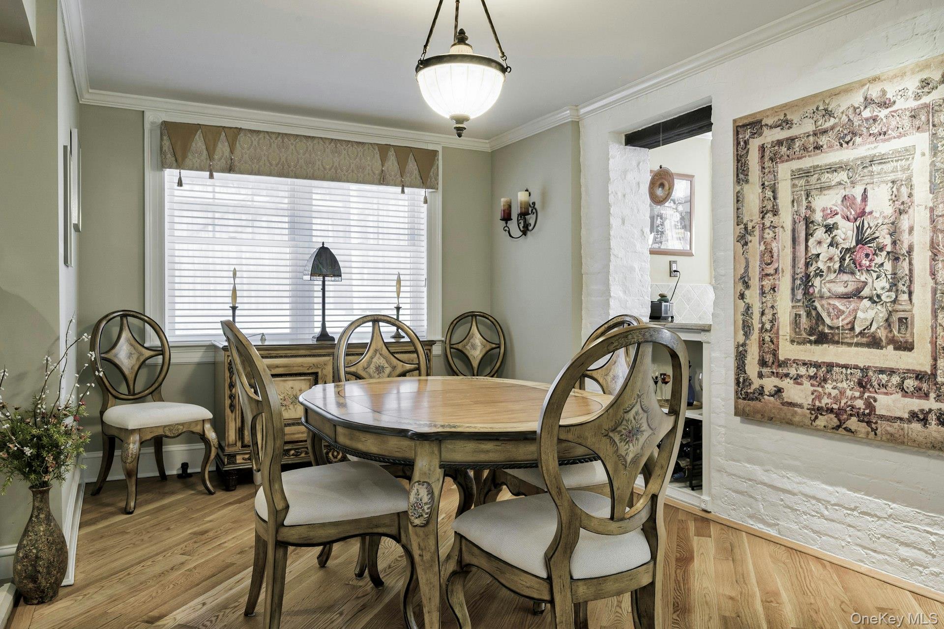 126 Cove Road Oyster Bay, NY 11771 - Photo 21 of 42 Dining space featuring wood finished floors and crown molding