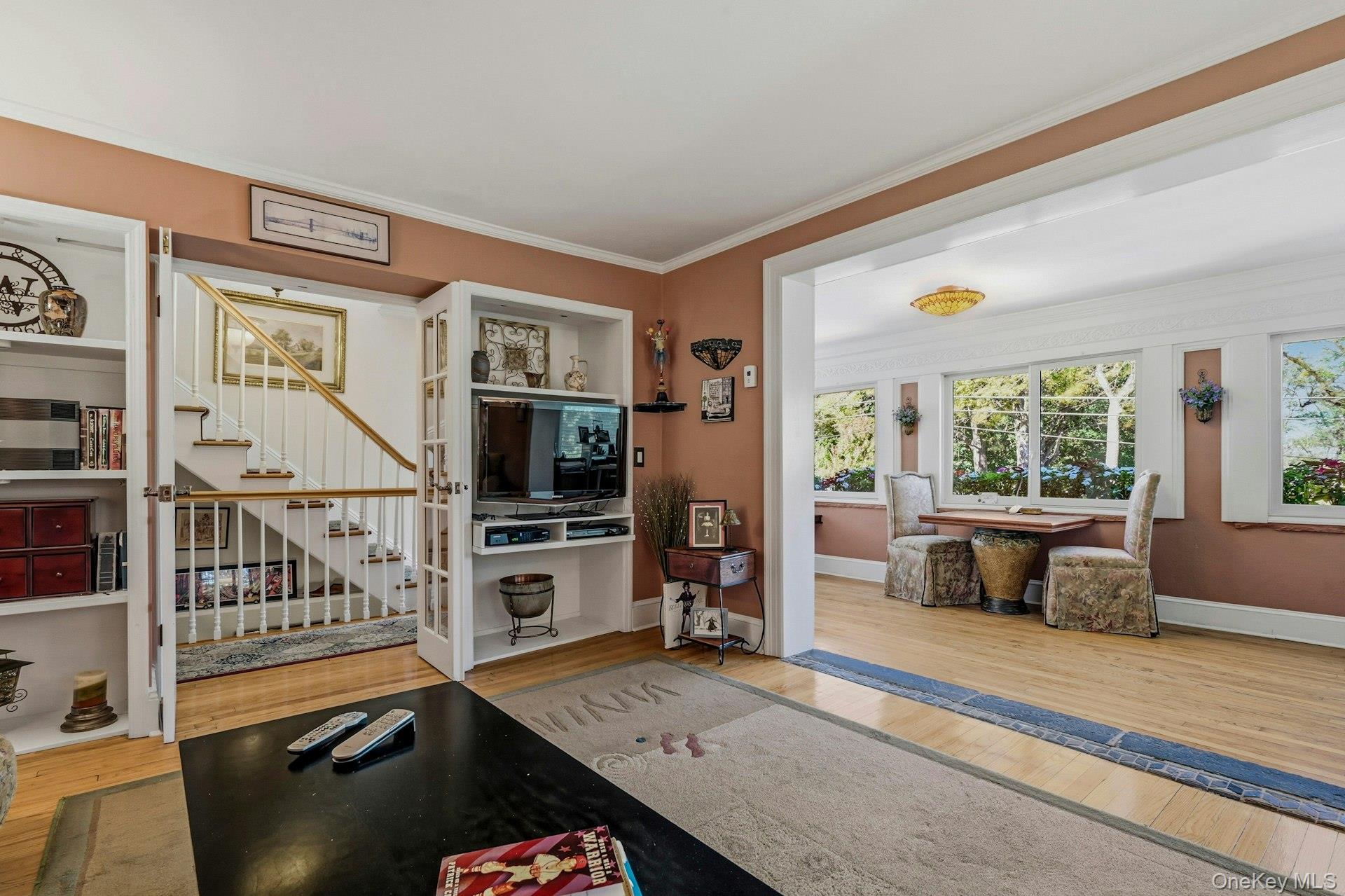 126 Cove Road Oyster Bay, NY 11771 - Photo 25 of 42 Living area featuring ornamental molding, light wood-style floors, and stairway