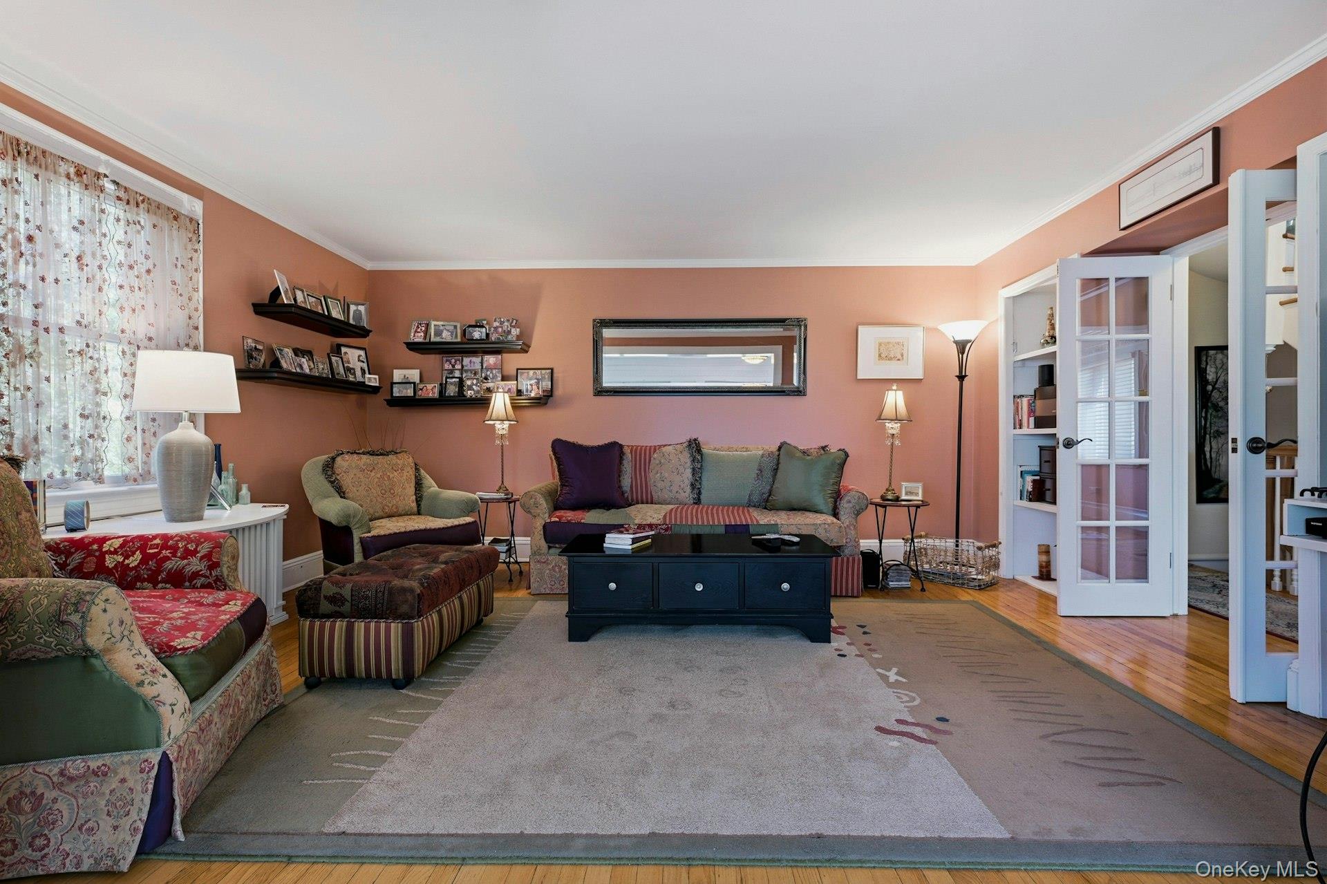 126 Cove Road Oyster Bay, NY 11771 - Photo 26 of 42 Living room with wood finished floors and crown molding