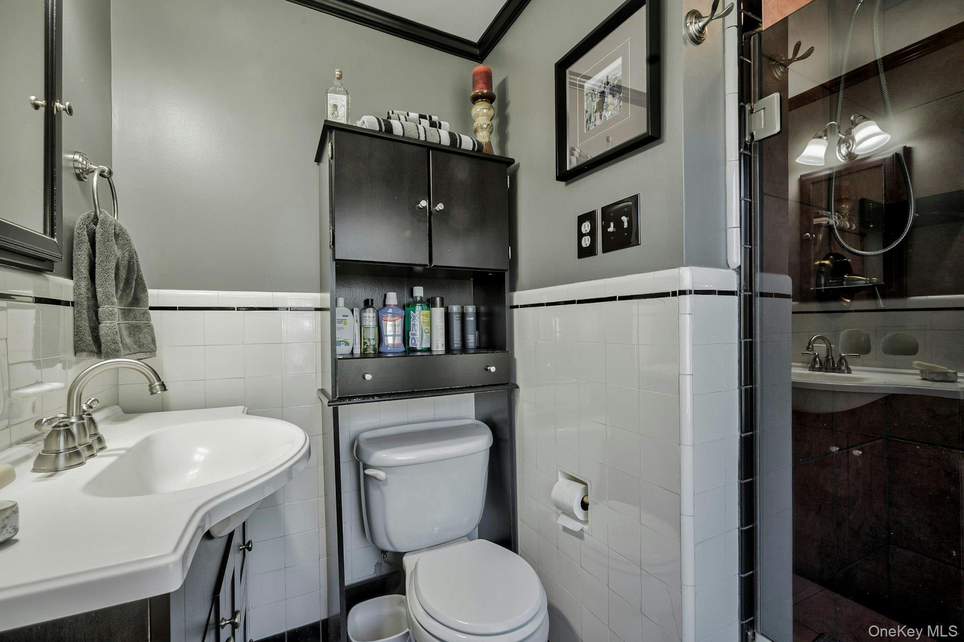 126 Cove Road Oyster Bay, NY 11771 - Photo 30 of 42 Bathroom with vanity, crown molding, tile walls, and wainscoting