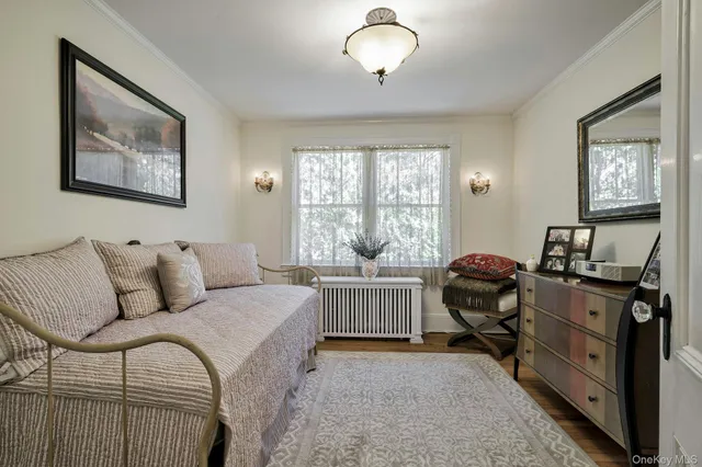 a view of a hallway with wooden floor and entryway
