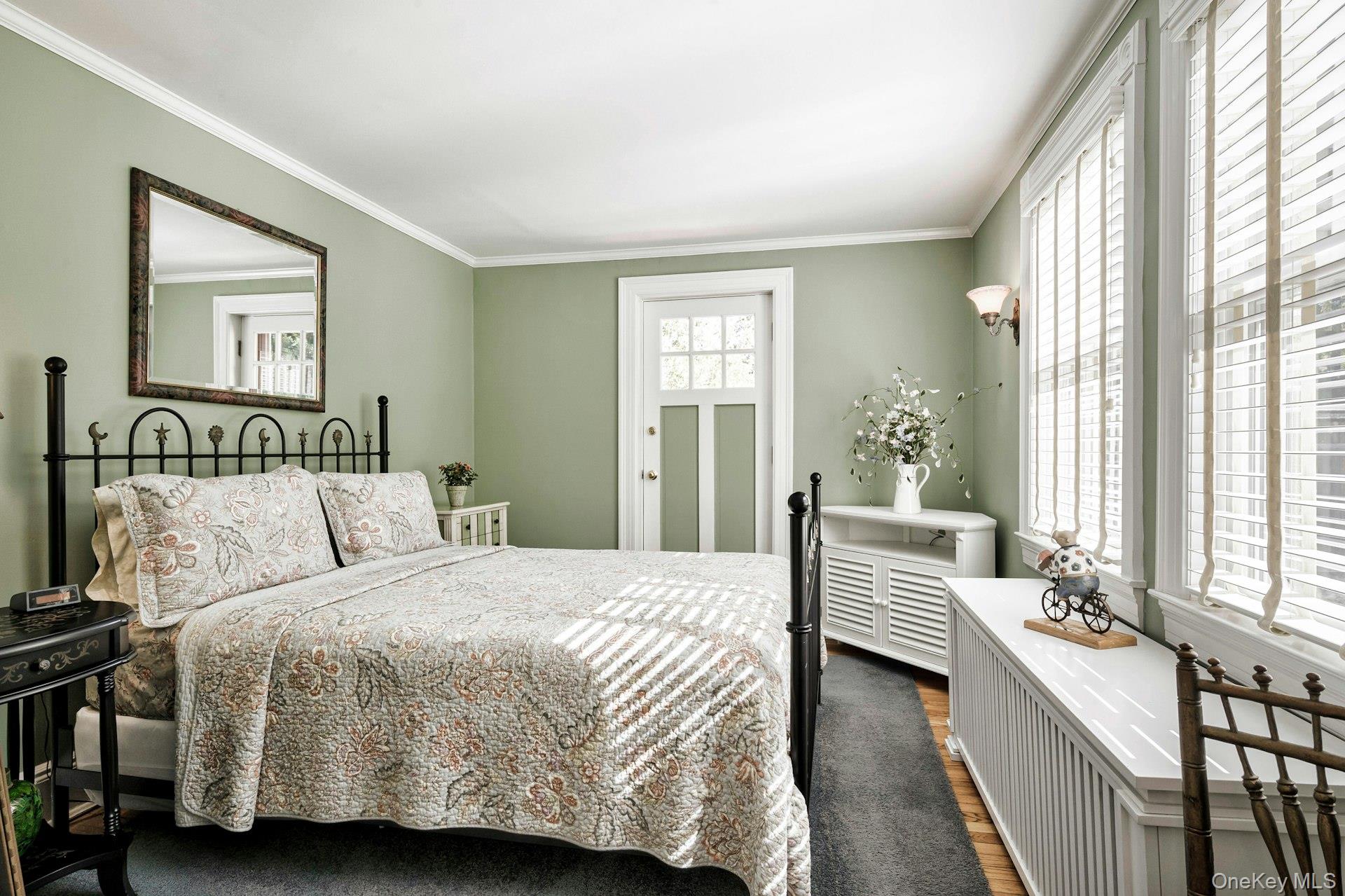 126 Cove Road Oyster Bay, NY 11771 - Photo 33 of 42 Bedroom with crown molding and dark wood-style flooring